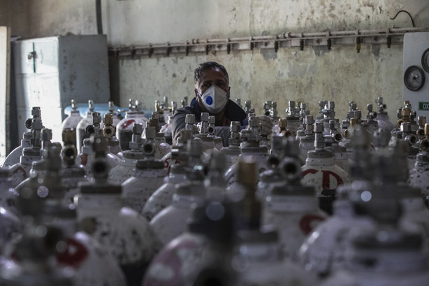 A hospital staff checks oxygen cylinders inside a hospital in Srinagar, Indian controlled Kashmir, Sunday, April 25, 2021.
