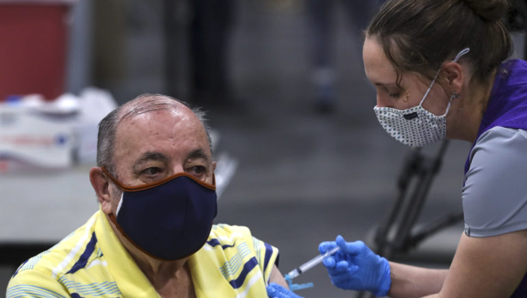 Richard Durrant receives his COVID-19 vaccine from Megan Boren, a Salt Lake County Health Department advanced EMT, at the countyâs mass vaccination site at the Mountain America Expo Center in Sandy on Monday, Jan. 18, 2021. Durrant and his wife, Joyce Durrant, were receiving their first doses of the Moderna vaccine.