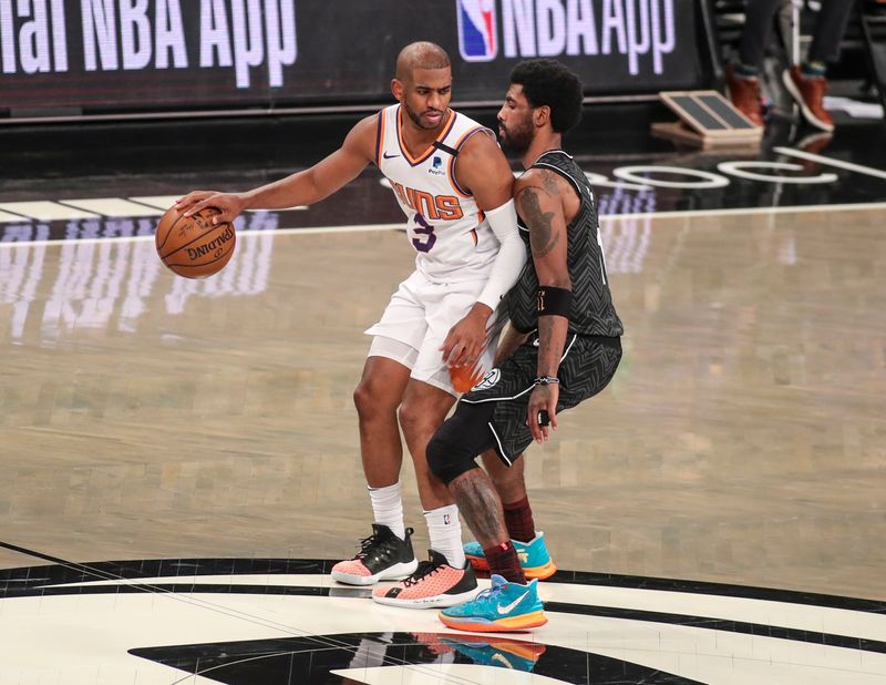Apr 25, 2021; Brooklyn, New York, USA; Phoenix Suns guard Chris Paul (3) is guarded by Brooklyn Nets guard Kyrie Irving (11) at Barclays Center. Mandatory Credit: Wendell Cruz-USA TODAY Sports