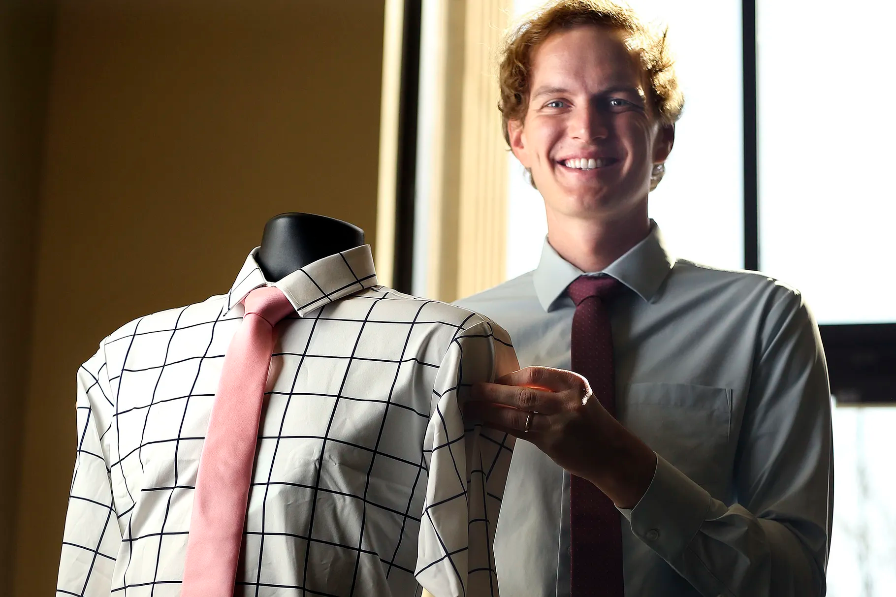 Ben Perkins, owner of &Collar, holds a men’s dress shirt that is made out of recycled plastic at &Collar in Salt Lake City on Thursday, April 8, 2021.