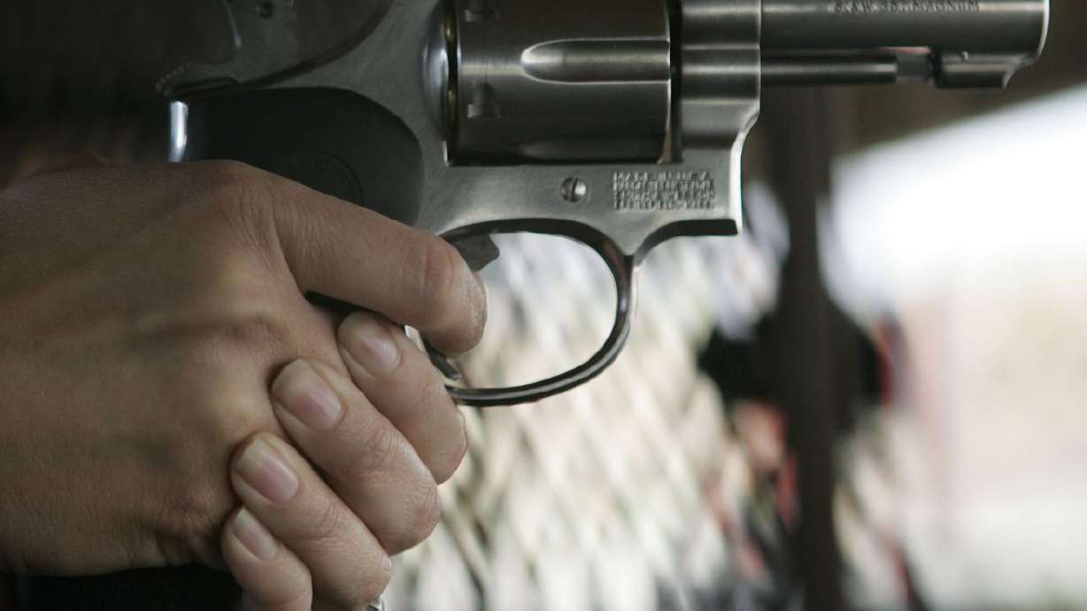 A student holds a gun during a conceal and carry
weapons certification for members of the media at Lee Kay Shooting
Range in Salt Lake City May 31, 2009.