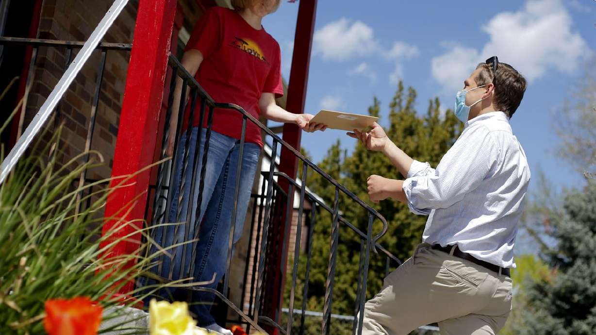 Nola Otterstrom signs a ballot qualification form for
Salt Lake City Council candidate Blake Perez in Salt Lake City on
Friday, April 23, 2021. To qualify for the ballot, council
candidates must collect at least 75 signatures from residents in
their district who are at least 18 years old.