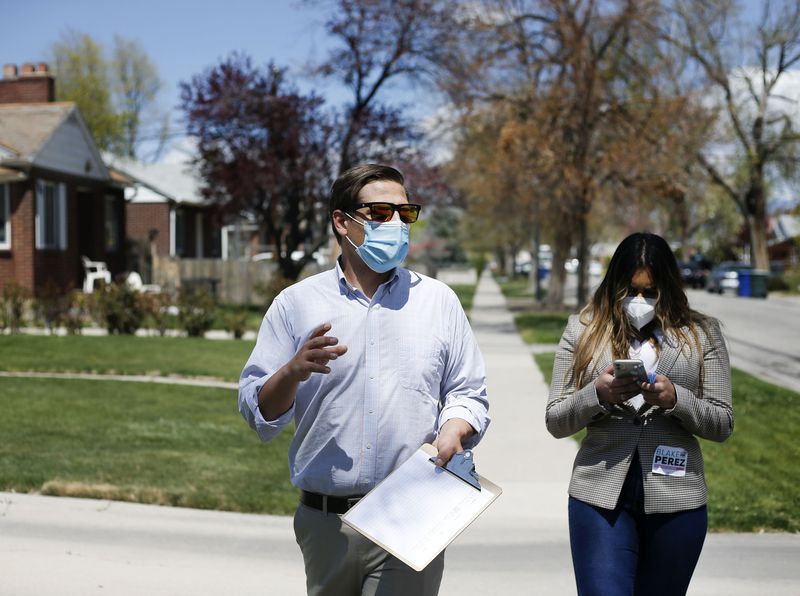 Salt Lake City Council candidate Blake Perez and his
intern, Lhyba Qazi, walk Perez’s neighborhood collecting signatures
in Salt Lake City on Friday, April 23, 2021. To qualify for the ballot, council candidates must collect at least 75 signatures from
residents in their district who are at least 18 years of
age.