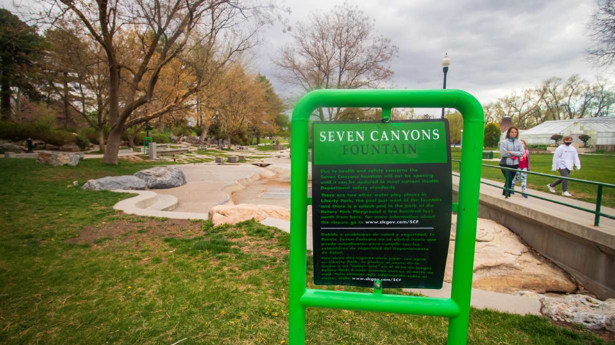 A sign indicating the Seven Canyons Fountain's water has been turned off stands in front of the fountain at Liberty Park on April 27, 2021. Salt Lake City officials say the fountain will be converted into a "dry art feature" in the future.
