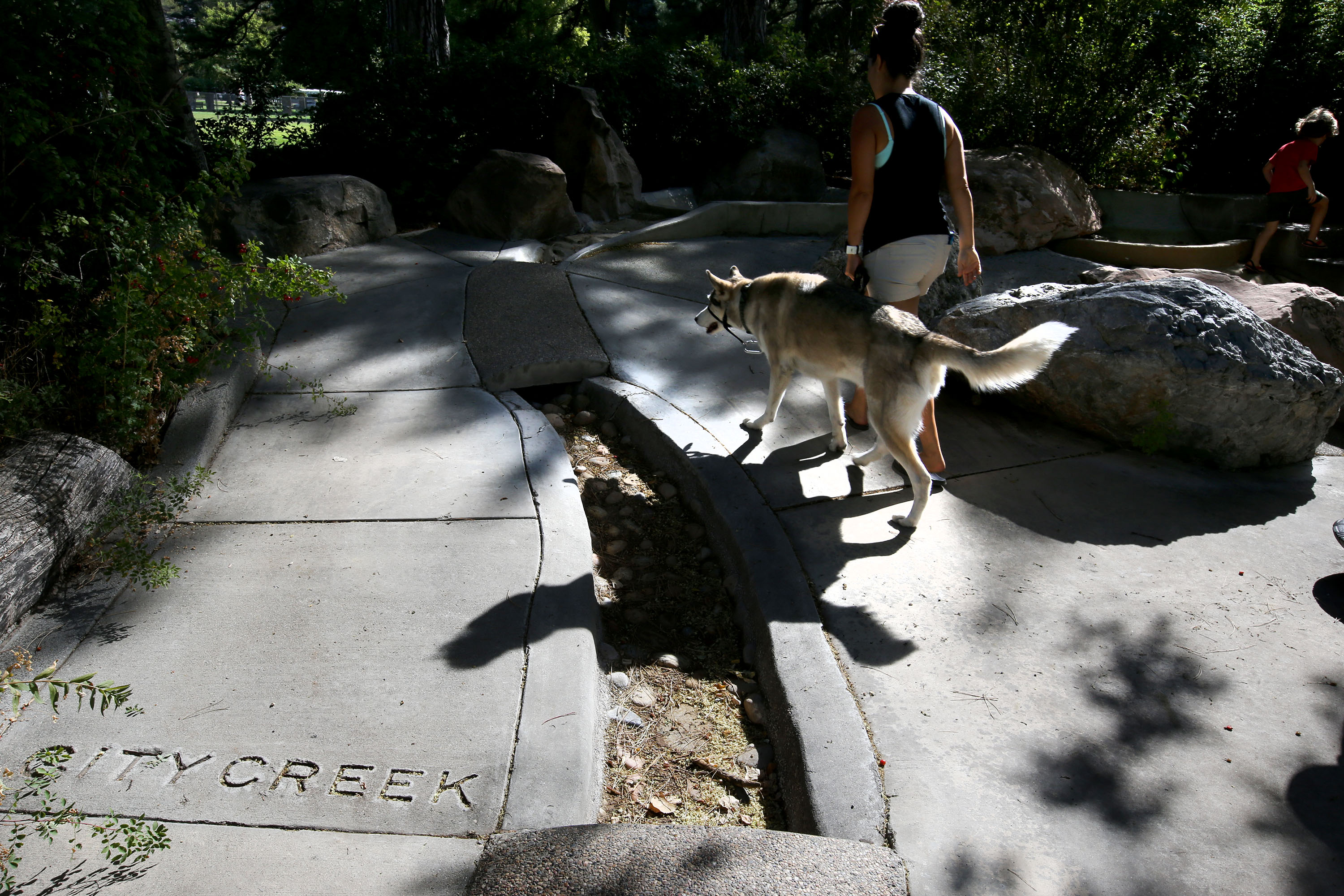 Danielle Torres walks her dog through Seven Canyons Fountain in Liberty Park in Salt Lake City on Wednesday, Sept. 13, 2017. The city has reported that it will take $1.95 million to repair the fountain.
