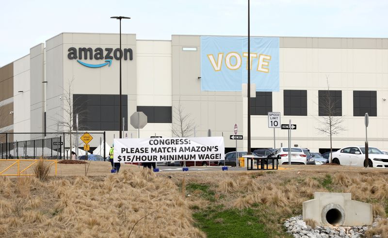 FILE PHOTO: Banners are placed at the Amazon facility as members of a congressional delegation arrive to show their support for workers who will vote on whether to unionize, in Bessemer, Alabama, U.S. March 5, 2021.  REUTERS/Dustin Chambers