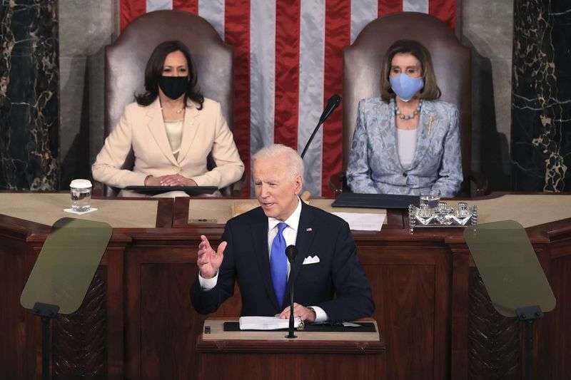 President Joe Biden addresses a joint session of
Congress on Wednesday, April 28, 2021, in the House Chamber at the
U.S. Capitol in Washington, as Vice President Kamala Harris, left,
and House Speaker Nancy Pelosi look on.