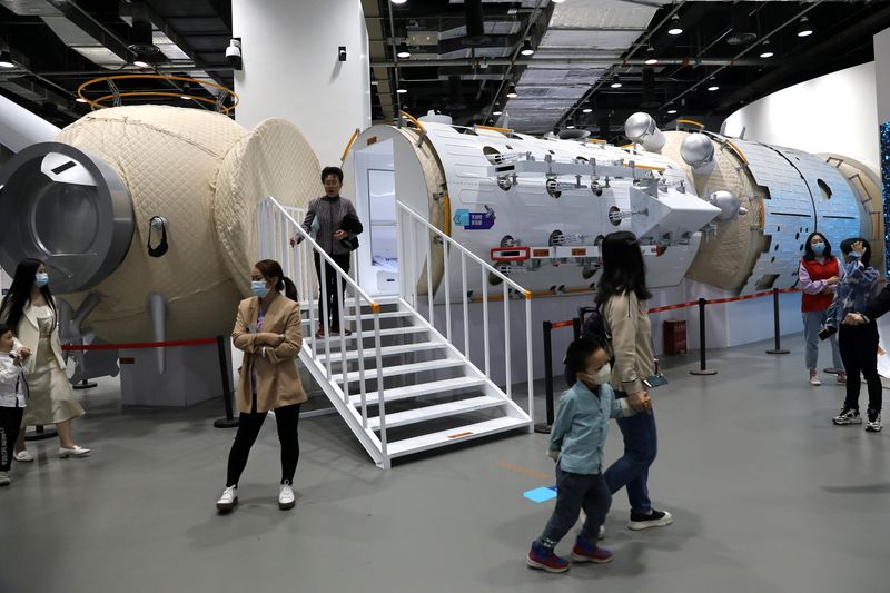 FILE PHOTO: Visitors walk near a model of the core module of the Tianhe space station at an exhibition featuring the development of China’s space exploration on the country's Space Day at China Science and Technology Museum in Beijing, China April 24, 2021. REUTERS/Tingshu Wang