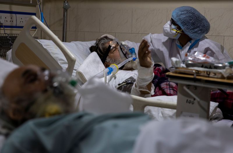 A medical worker tends to a patient suffering from the coronavirus disease (COVID-19) inside the ICU ward at Holy Family Hospital in New Delhi, India, April 29, 2021. REUTERS/Danish Siddiqui