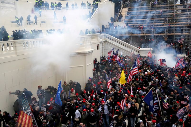 FILE PHOTO: Police release tear gas into a crowd of pro-Trump protesters during clashes at a rally to contest the certification of the 2020 U.S. presidential election results by the U.S. Congress, at the U.S. Capitol Building in Washington, U.S, January 6, 2021. REUTERS/Shannon Stapleton/File Photo