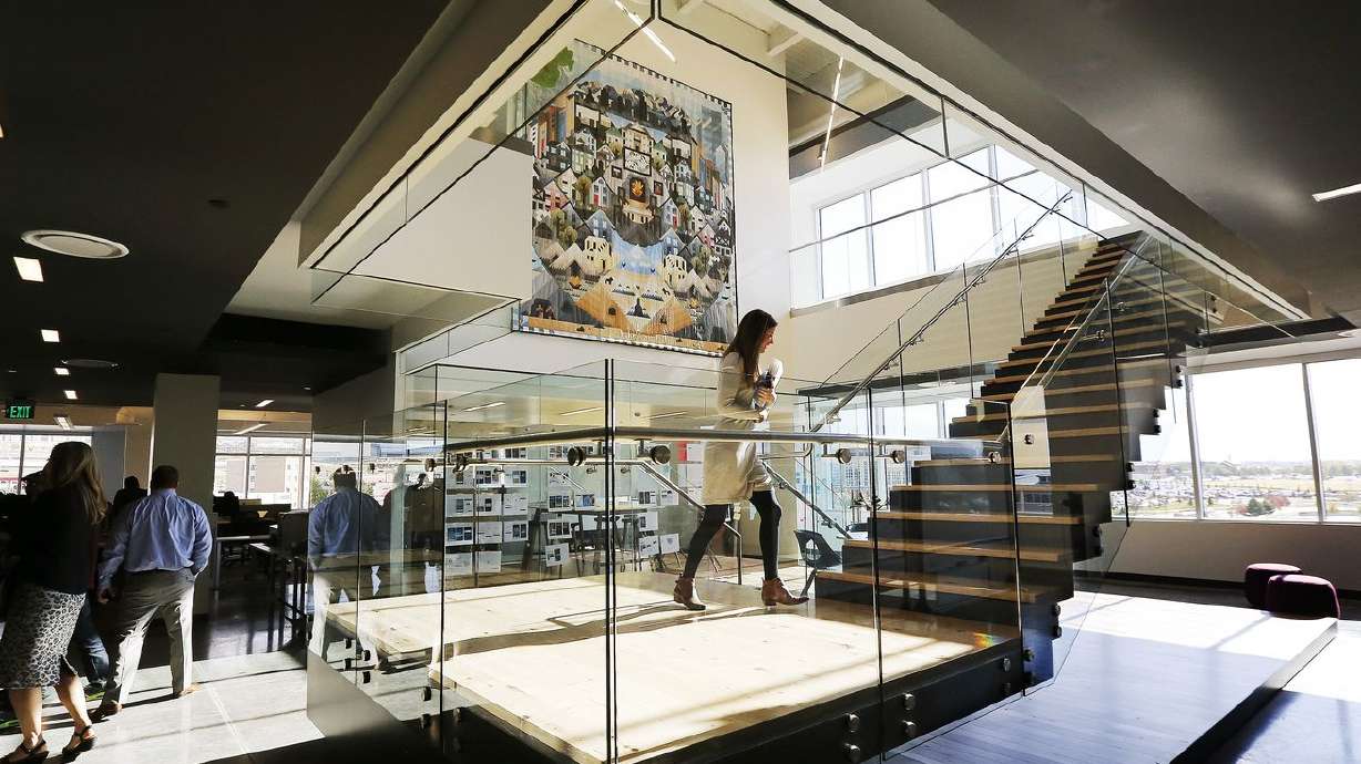 Employees walk through the building during Vivint’s
Innovation Center grand opening in Lehi on Oct. 21, 2014. On
Thursday, the Federal Trade Commission announced it had reached a
$20 million agreement with Vivint Smart Home over abuses of
customer credit information.
