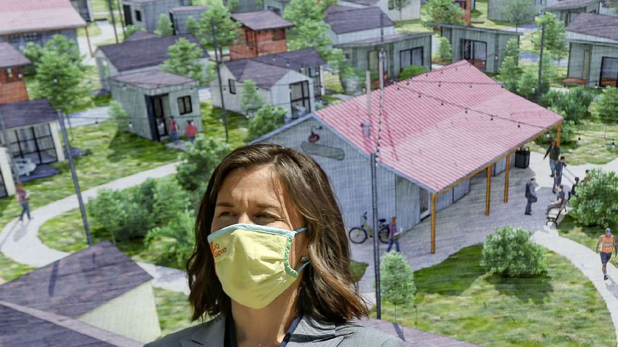 Salt Lake City Mayor Erin Mendenhall stands in front of
a conceptual drawing for The Other Side Village — a tiny home
community to serve people experiencing chronic homelessness —
during a press conference at the City-County Building on Thursday,
April 28, 2021. During the press conference, Mendenhall announced a
partnership with The Other Side Academy to create the community by
wintertime.