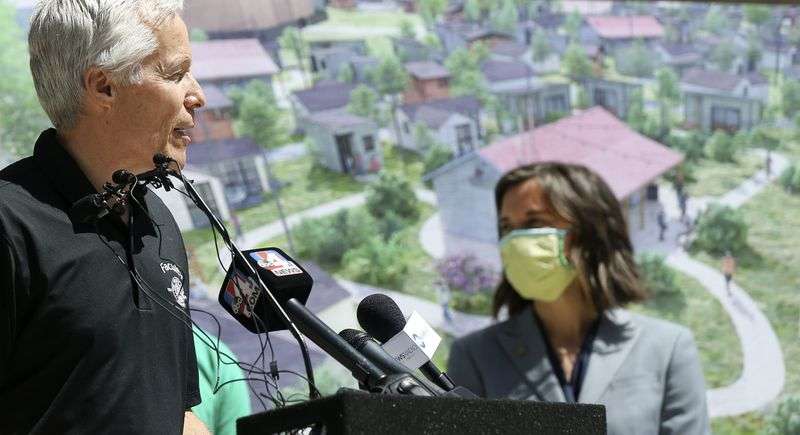 Joseph Grenny, chairman of The Other Side Academy,
left, discusses a partnership with Salt Lake City to create The
Other Side Village — a tiny home community to serve people
experiencing chronic homelessness — during a press conference at
the City-County Building on Thursday, April 28, 2021. At right is
Mayor Erin Mendenhall.