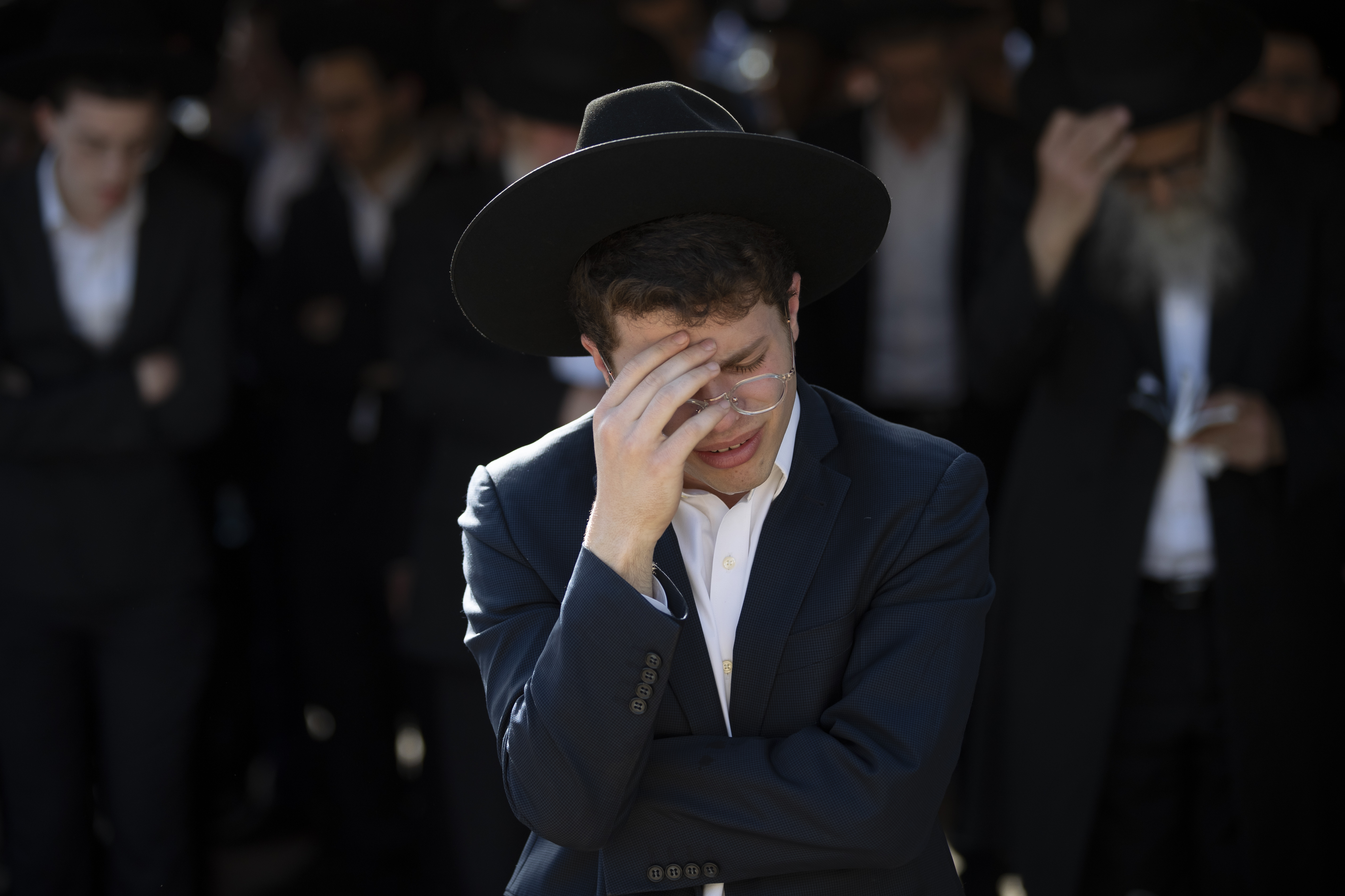 Ultra-Orthodox Jews mourn during the funeral of Moshe Ben Shalom at a cemetery in Petah Tikva, Israel, Friday, April 30, 2021.  Moshe Ben Shalom and several others died and others were injured during a stampede at Lag BaOmer celebrations, a religious festival attended by tens of thousands of ultra-Orthodox Jews in Mt. Meron, northern Israel early Friday. It was one of the country's deadliest civilian disasters 
