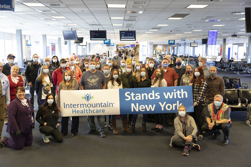 Intermountain Healthcare staffers hold a banner showing solidarity with health care workers in New York in April 2020.