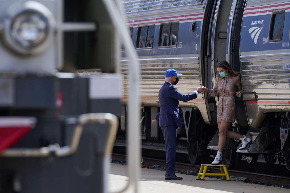 President Joe Biden offers his granddaugther Finnegan Biden a hand as she steps off a train car during an event to mark Amtrak's 50th anniversary at 30th Street Station in Philadelphia, Friday, April 30, 2021. (AP Photo/Patrick Semansky)
