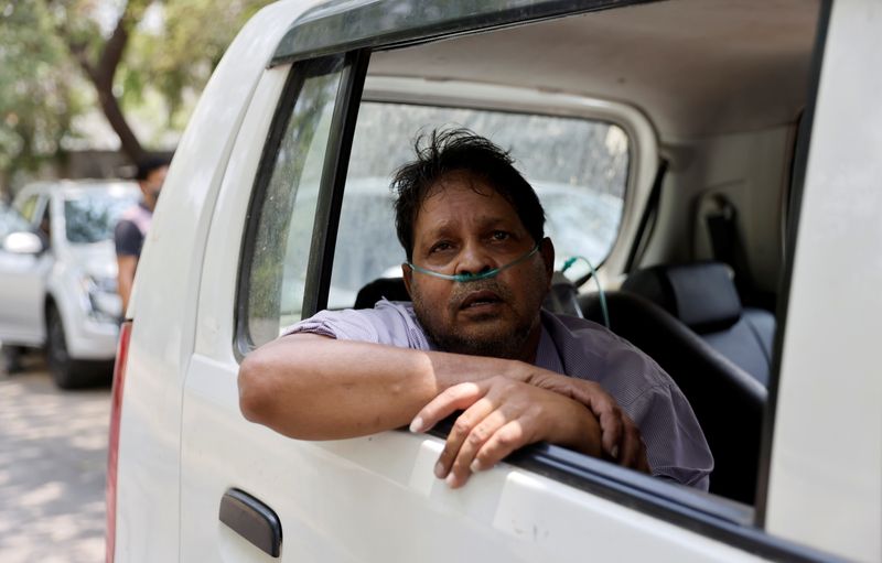 Vijay Gupta, 62, with breathing problem, sits inside a car as he waits to get admission at a COVID-19 hospital for treatment, amidst the spread of the coronavirus disease, in New Delhi, India, May 1, 2021.