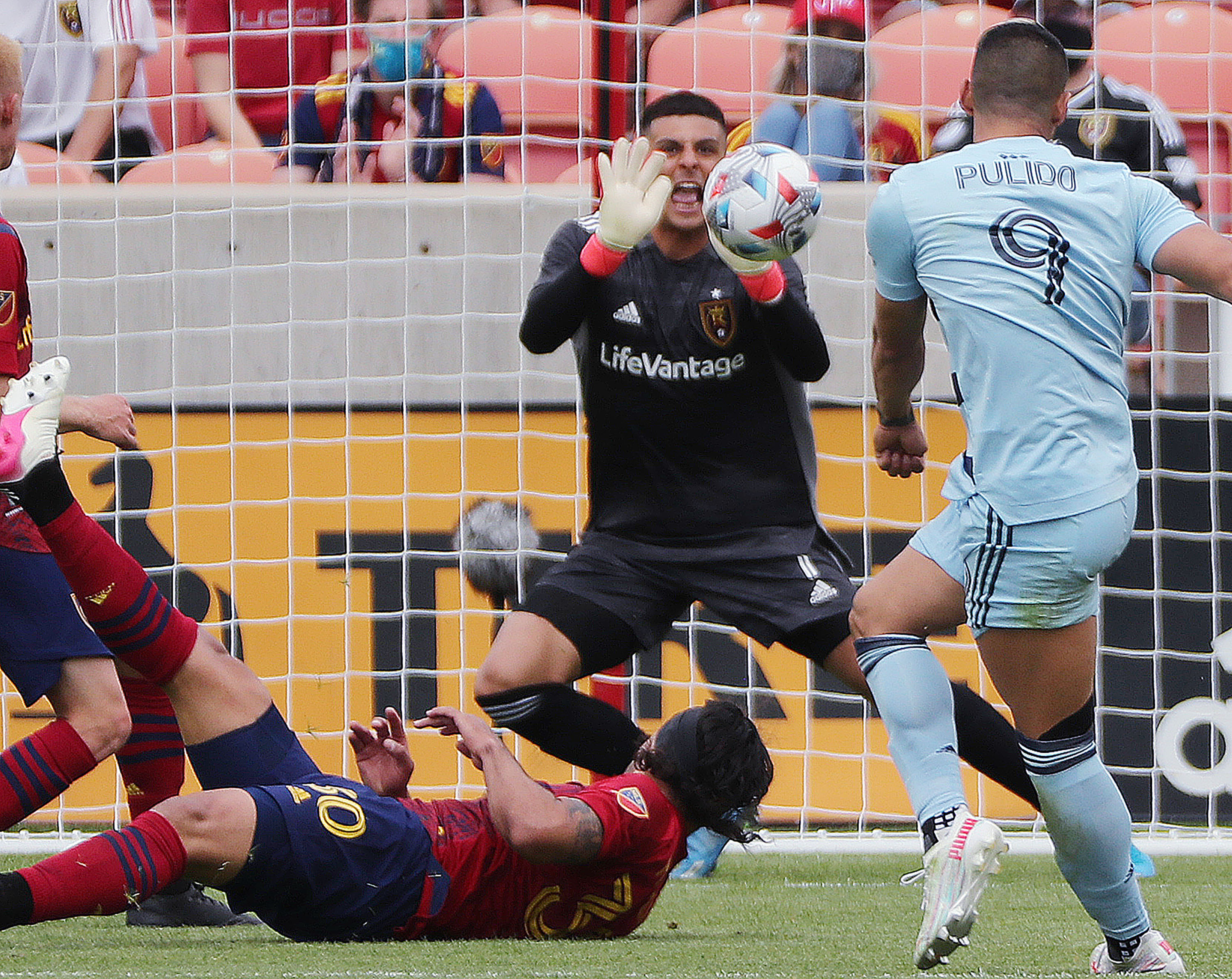 Real Salt Lake goalkeeper David Ochoa (1) makes a save on the kick by Sporting Kansas City forward Alan Pulido (9) in Sandy on Saturday, May 1, 2021.