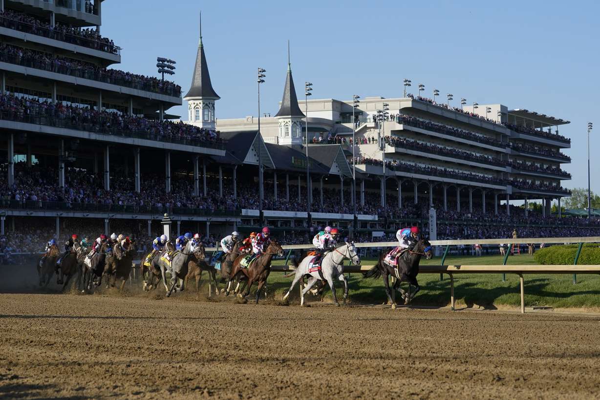 Medina Spirit, right, with John Velazquez aboard, leads the field around the first turn on the way to winning the 147th running of the Kentucky Derby at Churchill Downs, Saturday, May 1, 2021, in Louisville, Ky.