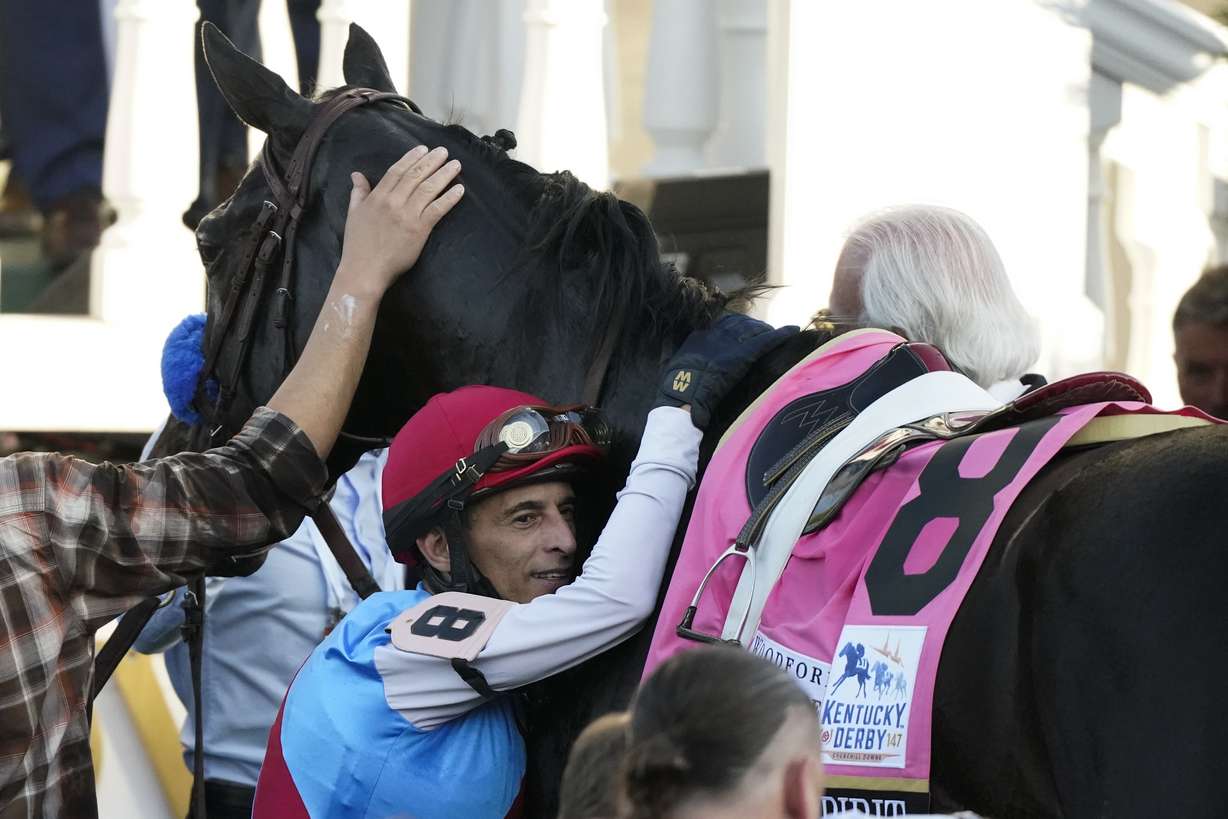 Jockey John Velazquez hugs Medina Spirit in the winner's circle after winning the 147th running of the Kentucky Derby at Churchill Downs, Saturday, May 1, 2021, in Louisville, Ky.