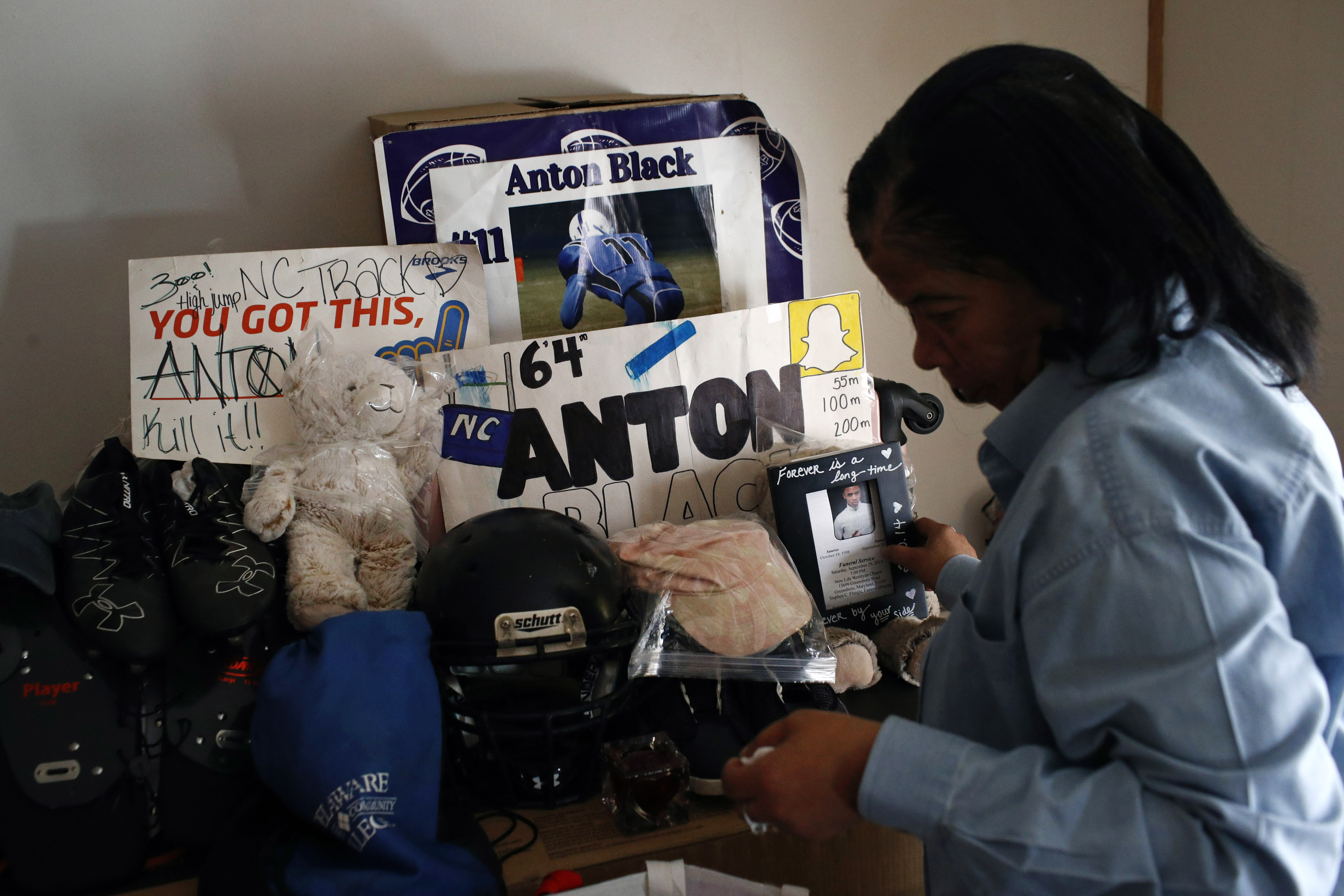 FILE - In this Jan. 28, 2019 file photo, Jennell Black, mother of Anton Black, looks at a collection of her son's belongings at her home in Greensboro, Md. Anton Black, 19, died after a struggle with three officers and a civilian outside the home in September 2018.  Cases involving police use of force often include questions about the internal records of the officers involved, records that in most cases are off-limits to the press and public. Lawmakers in at least 13 states have considered bills this year to make those records more publicly available. (AP Photo/Patrick Semansky, File)