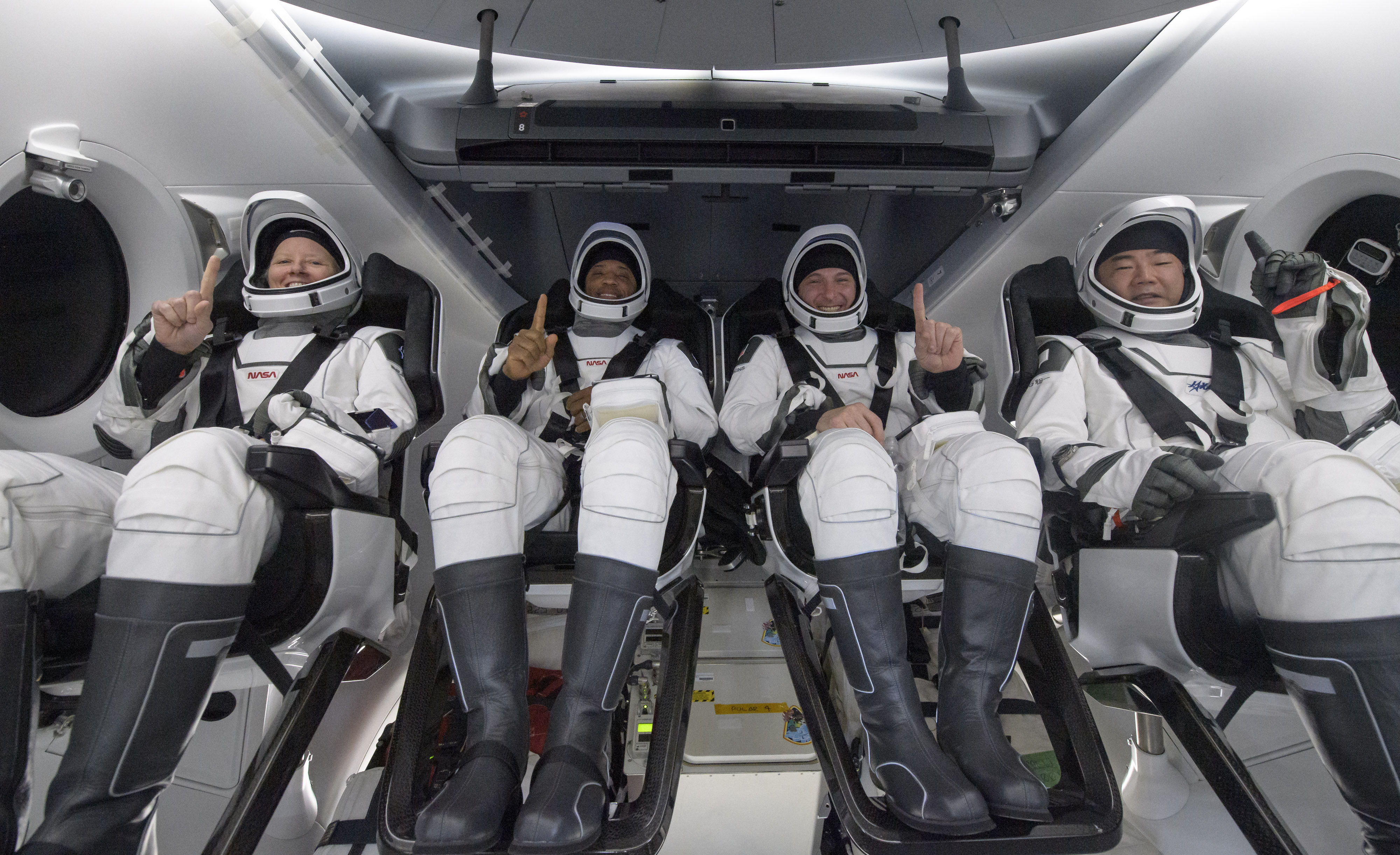 NASA astronauts Shannon Walker, left, Victor Glover, Mike Hopkins, and Japan Aerospace Exploration Agency (JAXA) astronaut Soichi Noguchi, right are seen inside the SpaceX Crew Dragon Resilience spacecraft onboard the SpaceX GO Navigator recovery ship shortly after having landed in the Gulf of Mexico off the coast of Panama City, Florida, Sunday, May 2, 2021. NASA's SpaceX Crew-1 mission was the first crew rotation flight of the SpaceX Crew Dragon spacecraft and Falcon 9 rocket with astronauts to the International Space Station as part of the agency's Commercial Crew Program. (Bill Ingalls/NASA via AP)