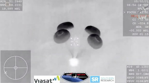 In this image made from NASA TV video, the SpaceX Dragon capsule lands into the Gulf of Mexico near the Florida Panhandle early Sunday, May 2, 2021. SpaceX returned four astronauts from the International Space Station on Sunday, making the first U.S. crew splashdown in darkness since the Apollo 8 moonshot.
