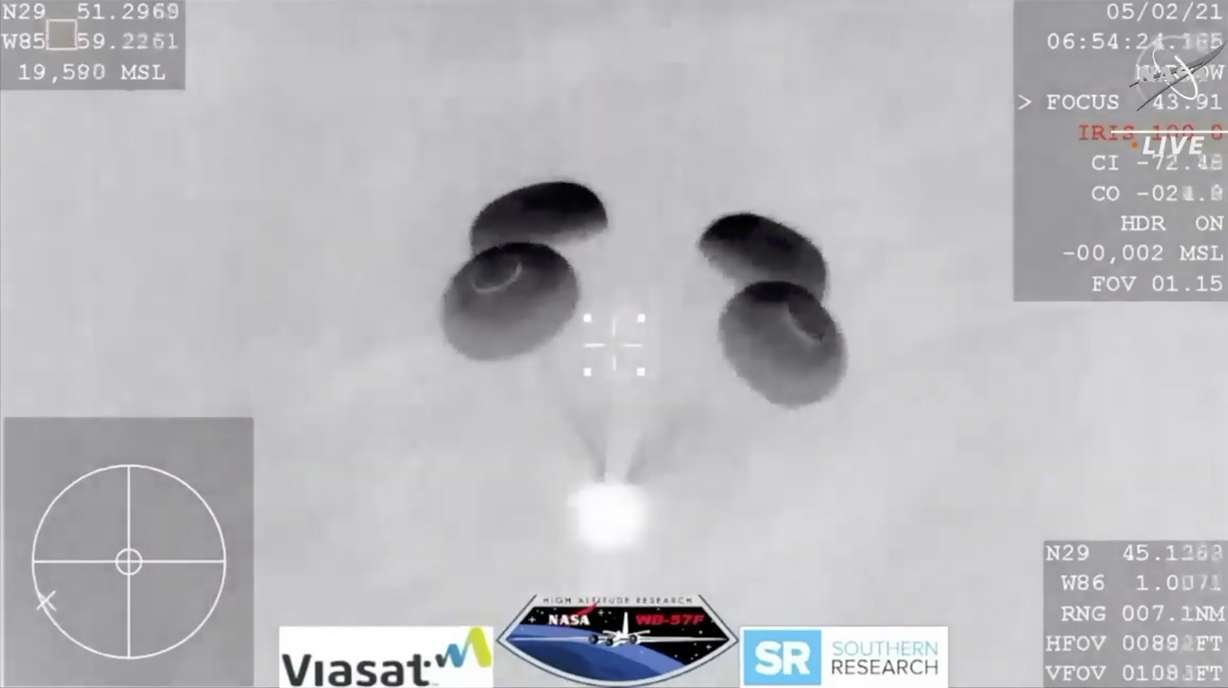 In this image made from NASA TV video, the SpaceX Dragon capsule lands into the Gulf of Mexico near the Florida Panhandle early Sunday, May 2, 2021. SpaceX returned four astronauts from the International Space Station on Sunday, making the first U.S. crew splashdown in darkness since the Apollo 8 moonshot.