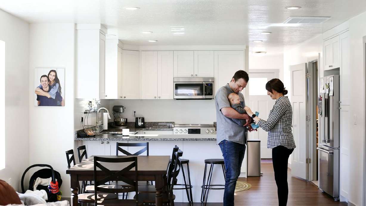 Mark, left, and Missy Haslam play with their son,
Maverick, in their net-zero home in Ogden on Wednesday, April 27,
2021. The Weber State University-driven project took first place
internationally for its energy performance in a fierce competition,
beating out eight other teams.