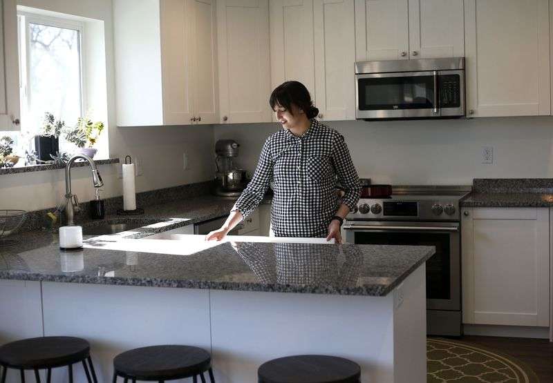 Missy Haslam prepares to make a meal in her net-zero
home in Ogden on Wednesday, April 27, 2021. High-efficiency
appliances were installed in the all-electric, net-zero energy
home. The Weber State University-driven project took first place
internationally for its energy performance in a fierce competition,
beating out eight other teams.