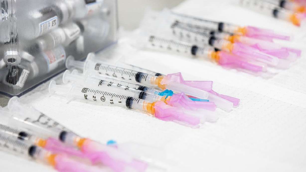 Doses of the Moderna COVID-19 vaccine are prepared at the Mountain America Expo Center in Sandy on April 22.