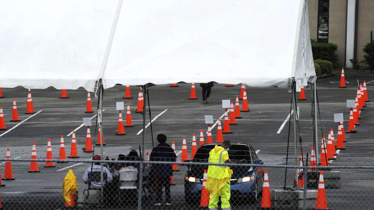 Workers at a mostly empty COVID-19 vaccination clinic located at Cathedral of the Cross A.O.H. Church of God in Birmingham, Ala., are shown on Monday, May 3, 2021. Health officials say vaccine demand is on the decline in some places, and Alabama Gov. Kay Ivey said she will soon end a state health order and state of emergency enacted because of the coronavirus pandemic. (AP Photo/Jay Reeves)