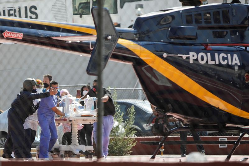 Paramedics transport Brandon Giovani Hernandez, who was injured during the accident where an overpass of the metro partially collapsed with train cars on it at Olivos station, toward a helicopter as he is transferred to another hospital, in Mexico City, Mexico May 4, 2021.