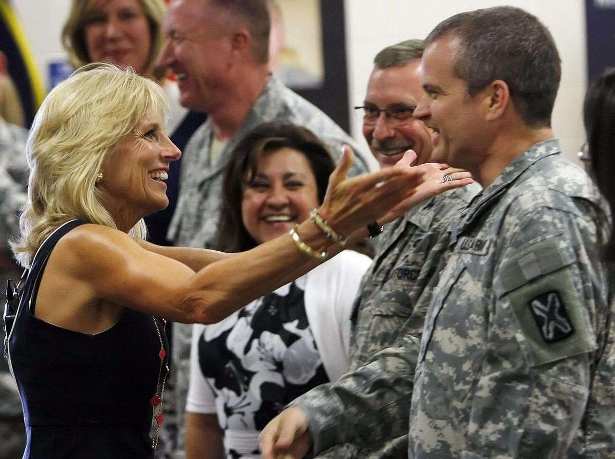 FILE - Jill Biden, wife of Vice President Joe Biden, greets command sergeant major Stephan Vogl as she enters the room during a stop to visit military families at the Utah National Guard base in Salt Lake City Tuesday, July 10, 2012.
