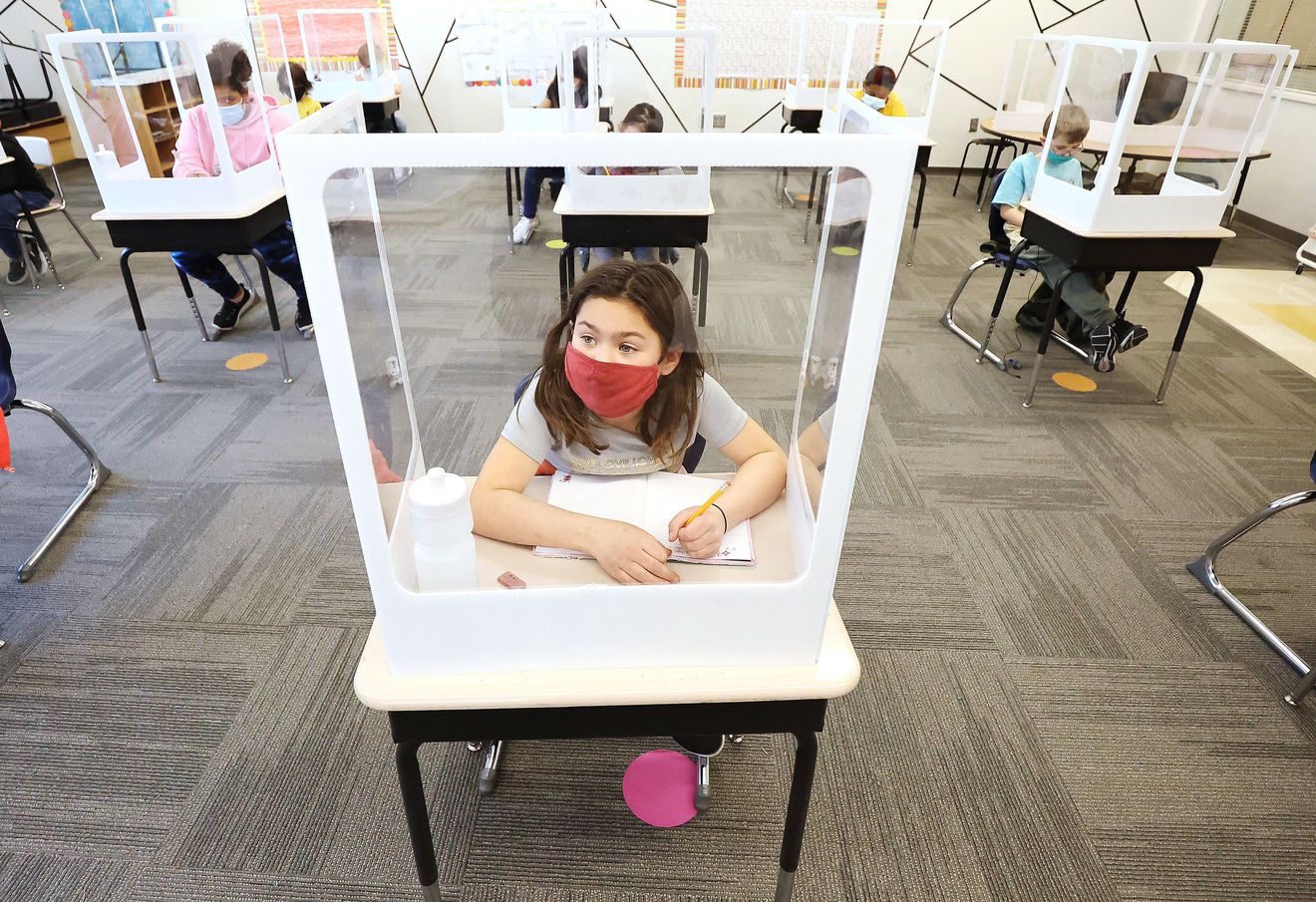 Third grader Lilly Kinikini keeps socially distanced in class at Washington Elementary School in Salt Lake City on March 19, 2021.
