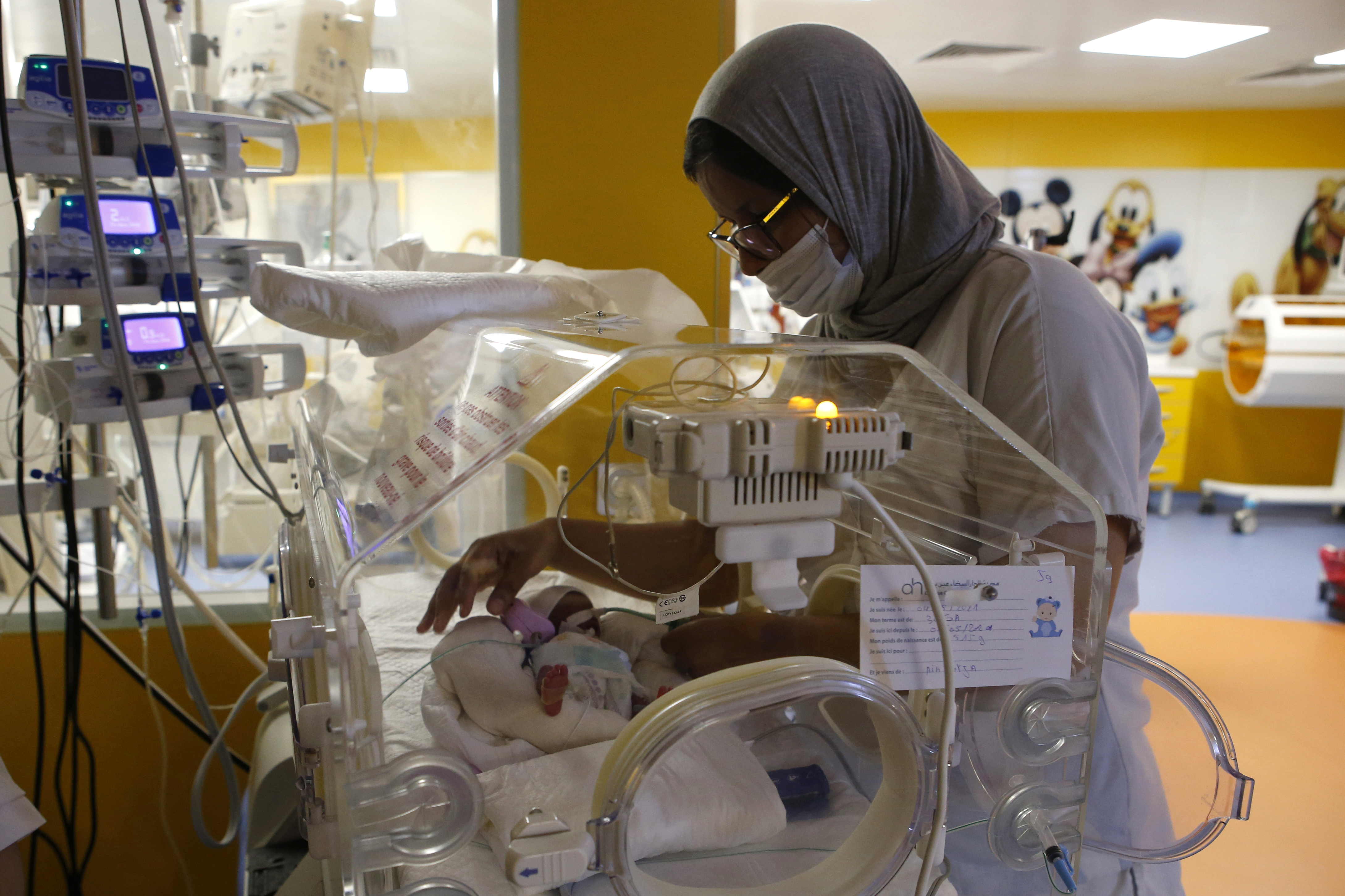 A Moroccan nurse takes care of one of the nine babies protected in an incubator at the maternity ward of the private clinic of Ain Borja in Casablanca, Morocco, Wednesday, May 5, 2021. A Malian woman gave birth to nine babies after n ' to have waited only seven, announced Wednesday the Ministry of Health of Mali. . Halima CissÈ, 25, gave birth by caesarean section Tuesday in Morocco after being sent there for special care, the ministry said. (AP Photo / Abdeljalil Bounhar) [May-05-2021]