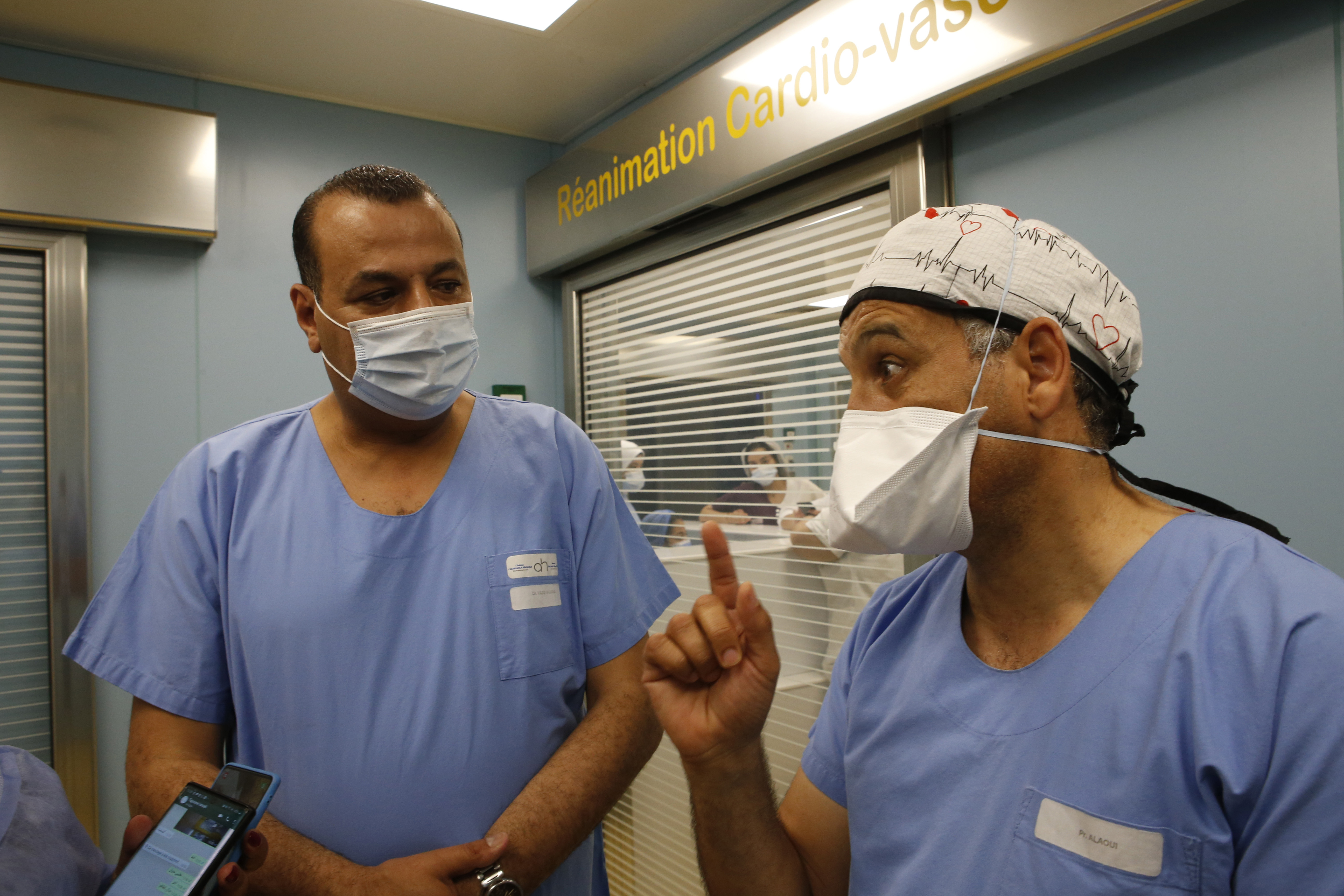 Surgeons Doctor Yazid, left, listens to the clinic's director Youssef Alaoui as they speak to the media on the conditions of childbirth at the maternity ward of the private clinic of Ain Borja in Casablanca, Morocco, on Wednesday, May 5, 2021.