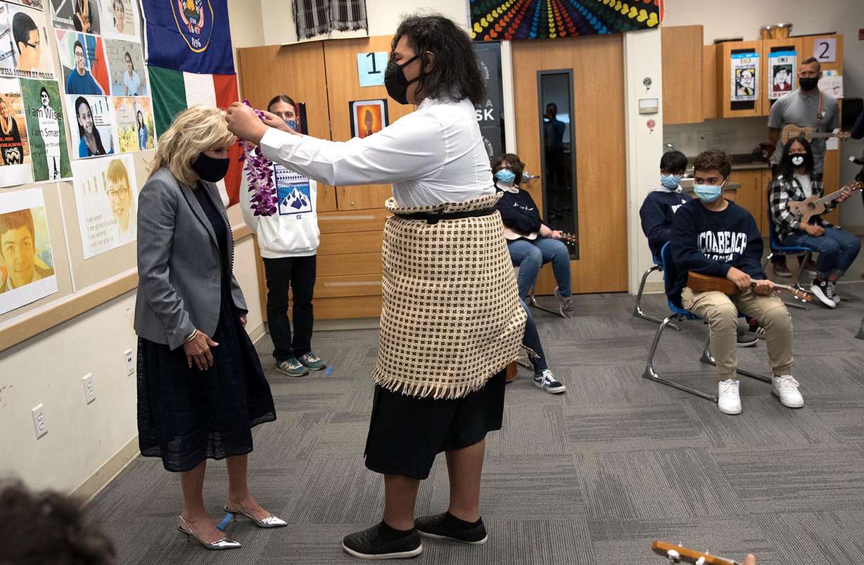 First lady Jill Biden receives a lei from Eli Kaufusi, a student at Glendale Middle School in Salt Lake City, on Wednesday, May 5, 2021.