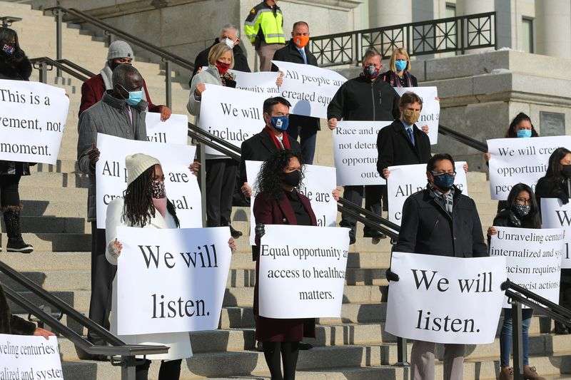 People from different nationalities join then-Gov. Gary
Herbert and other community leaders in the unveiling of the Utah
Compact on Racial Equity, Diversity, and Inclusion at the Capitol
in Salt Lake City on Dec. 15, 2020.