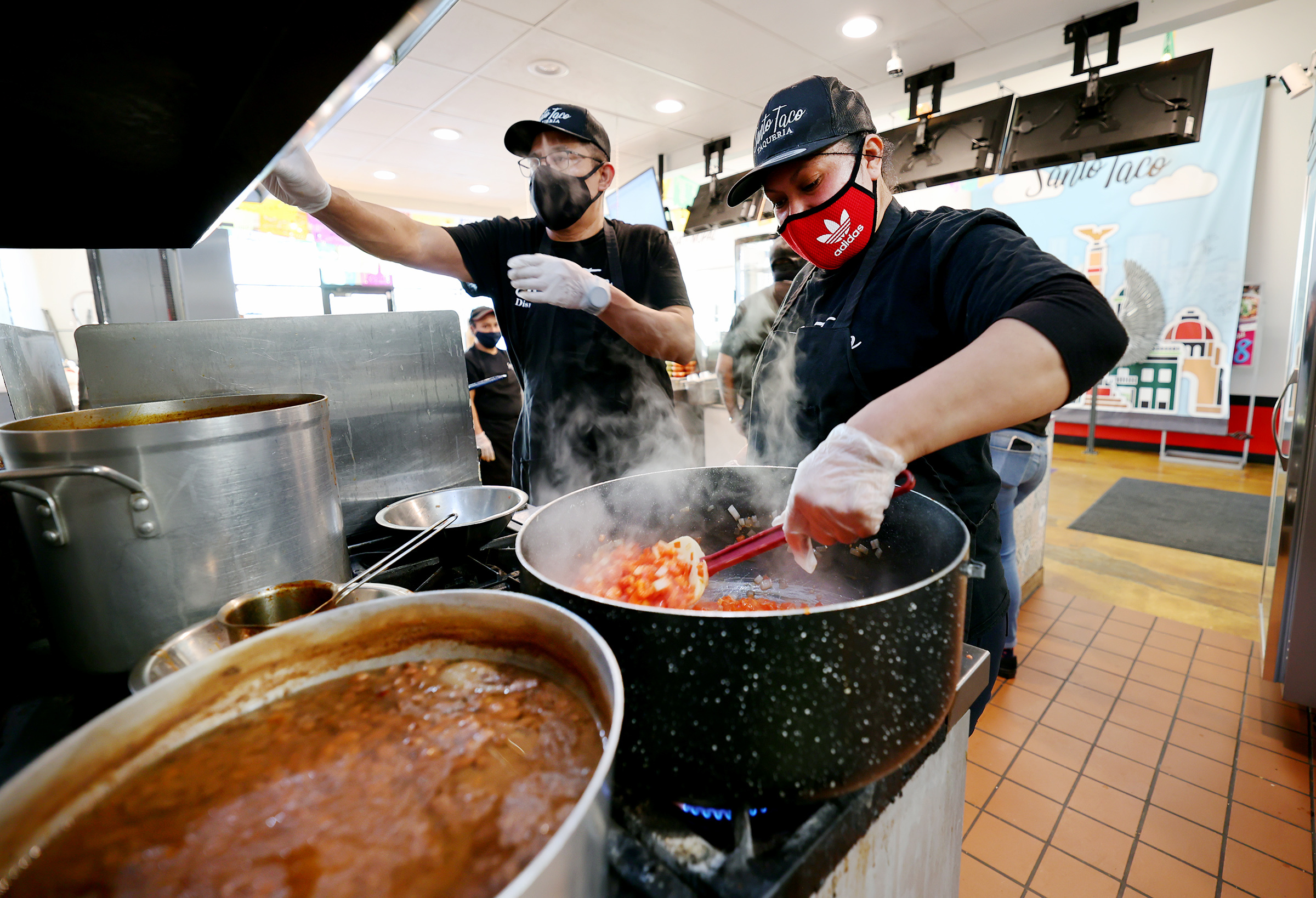 Augustina Ortega and Sergio Castino work at Santo Taco in Salt Lake City on Wednesday, Dec. 9, 2020. According to census data, Utahns as a whole are bringing in more money, but those of minority racial and ethnic backgrounds arenât taking home equal pieces of the pie.