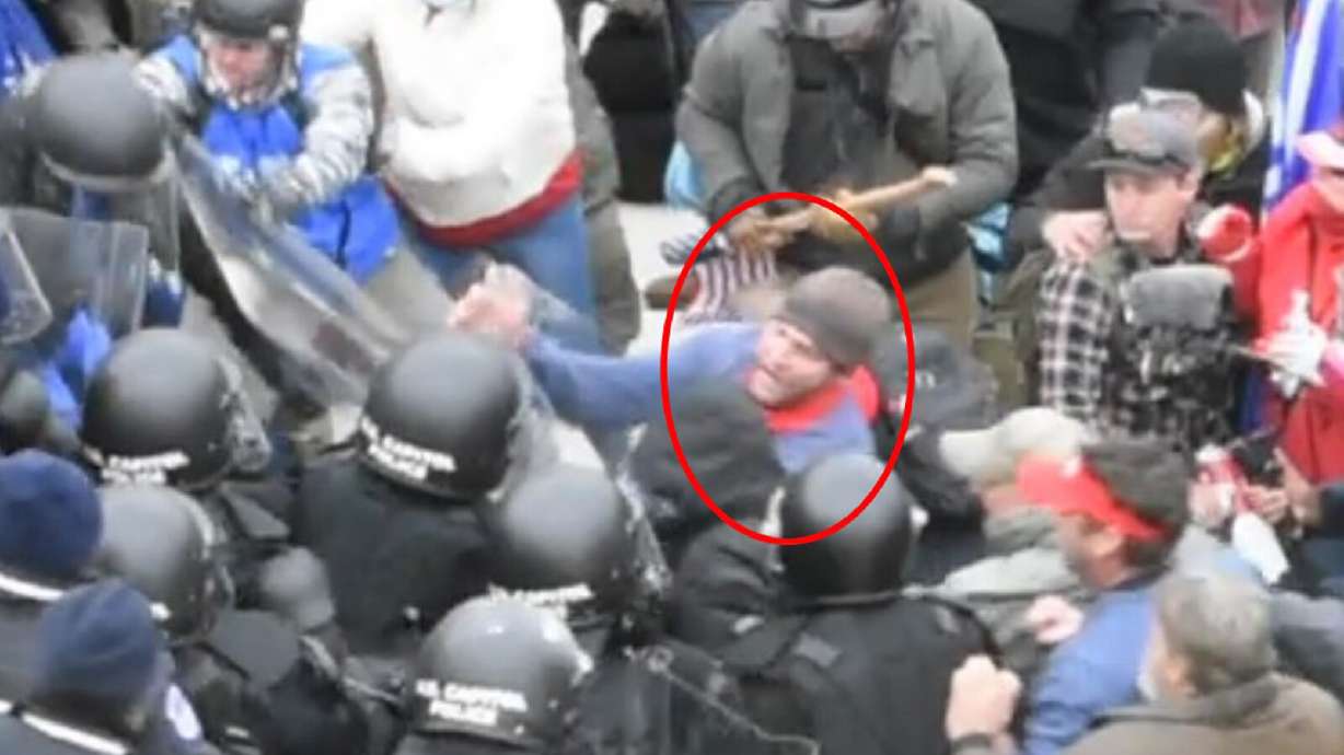 In a screenshot from Landon Kenneth Copeland’s federal complaint, an image shows a man identified as Copeland struggling with Capitol police officers over a barricade during the insurrection at the U.S. Capitol on Jan. 6.