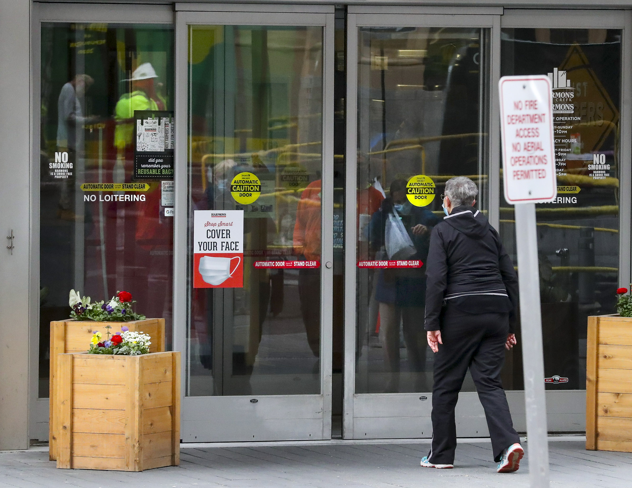 
Signs remind customers to wear a mask while shopping at the Harmons grocery store in downtown Salt Lake City on Tuesday, April 6, 2021.