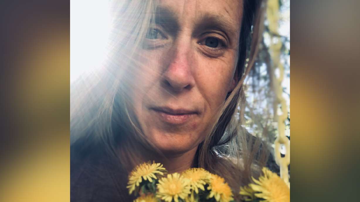 Arianne Brown holds the bouquet of flowers her son picked for her.