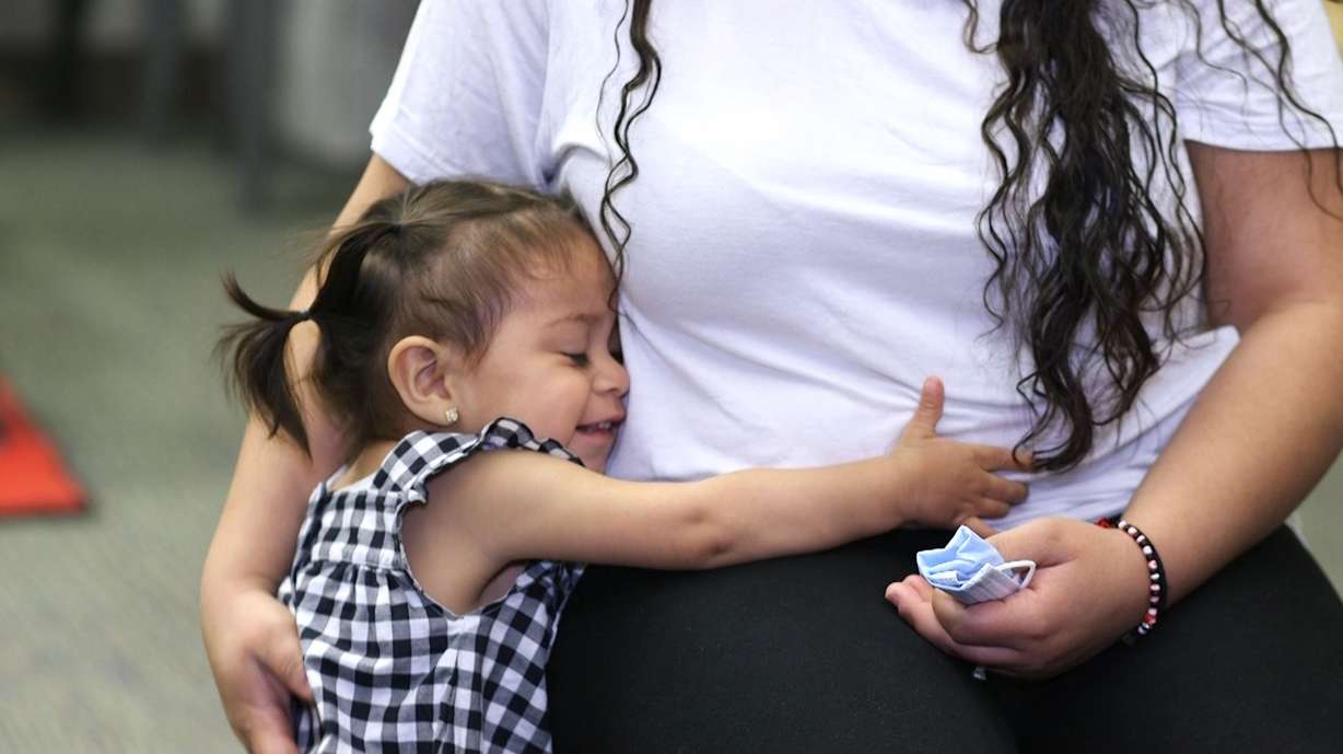 Young 22-month-old Loretta Vigil gives her mom a big hug.
