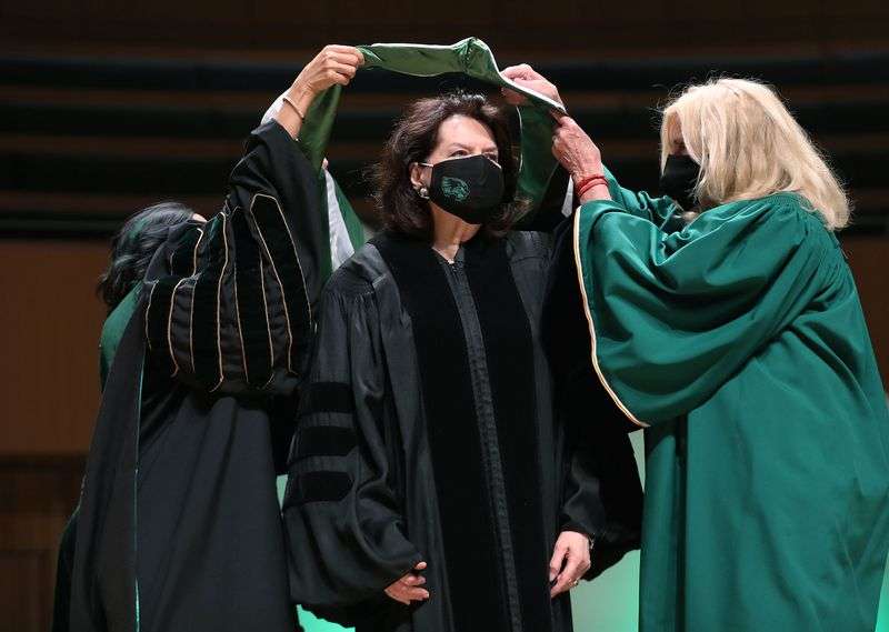 Sister Wendy Nelson receives her honorary degree from
UVU President Astrid Tuminez and UVU board of trustees member Elaine
Dalton at Utah Valley University’s graduation in Orem on Friday,
May 7, 2021.