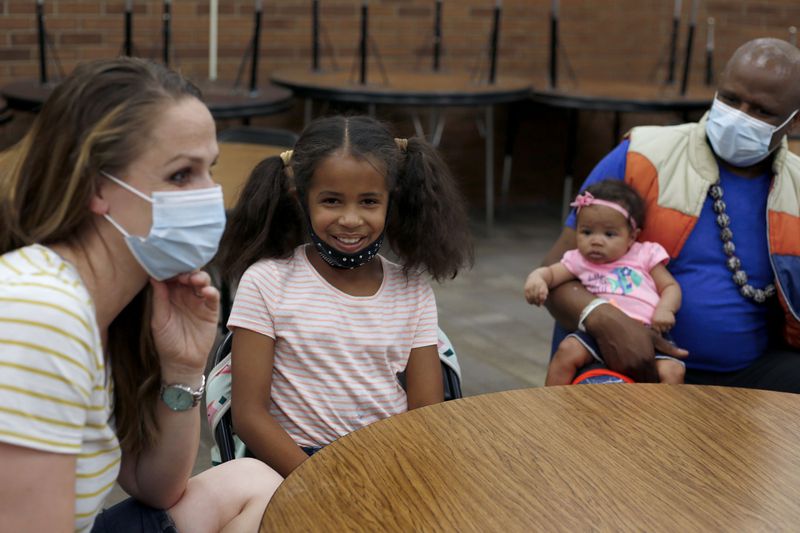 India Boyé, 8, center, talks with her parents, Julie,
left, and Alex, and her baby sister Nayoma at Willow Canyon
Elementary School in Sandy on Thursday, May 6, 2021. India won the
national PTA Reflections contest for her song about being
biracial.