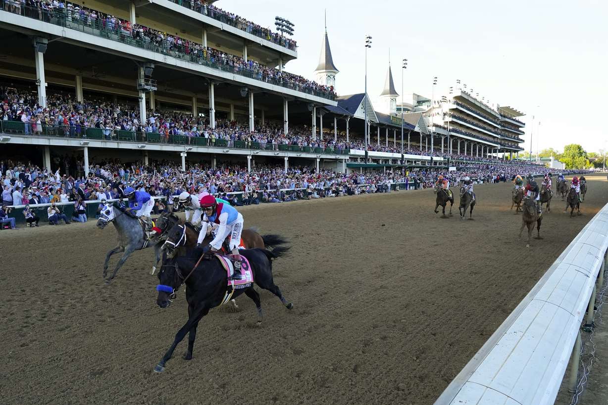 John Velazquez riding Medina Spirit leads Florent Geroux on Mandaloun, Flavien Prat riding Hot Rod Charlie and Luis Saez on Essential Quality to win the 147th running of the Kentucky Derby at Churchill Downs, Saturday, May 1, 2021, in Louisville, Ky.
