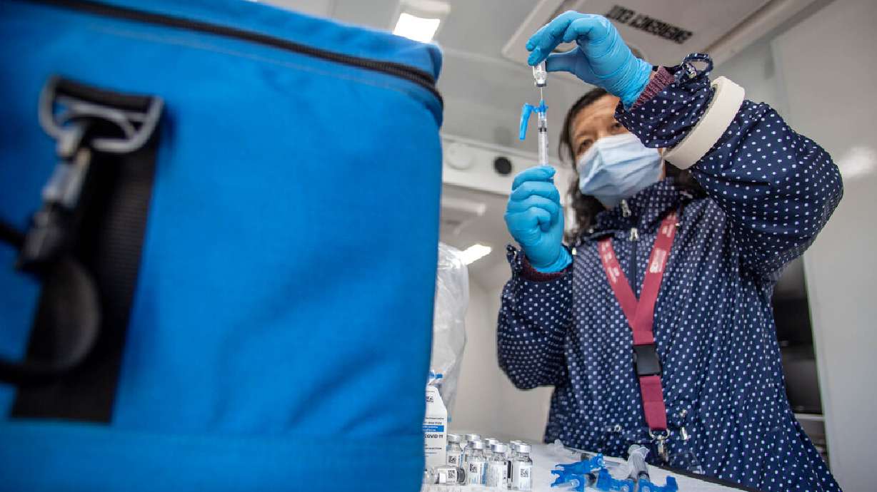 Health care worker Qing Chong prepares COVID-19 vaccines for a pop-up vaccination event at Reams in Magna on May 3, 2021. The Utah Department of Health reported 1,050 more COVID-19 cases, eight deaths and 8,379 vaccinations on Wednesday.