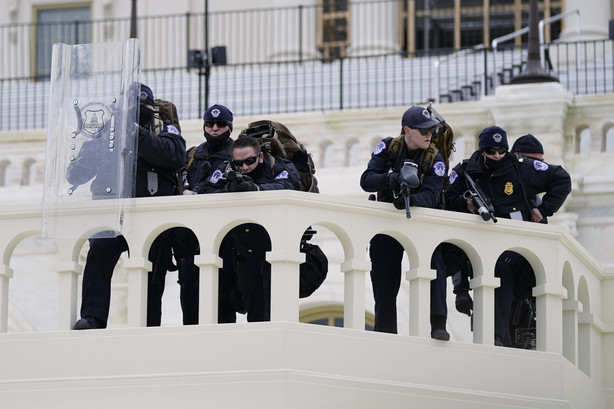 FILE - In this Jan. 6, 2021, file photo, police keep a watch on demonstrators who tried to break through a police barrier at the Capitol in Washington. A blistering internal report by the U.S. Capitol Police describes a multitude of missteps that left the force unprepared for the Jan. 6 insurrection — riot shields that shattered upon impact, expired weapons that couldn’t be used, inadequate training and an intelligence division that had few set standards.