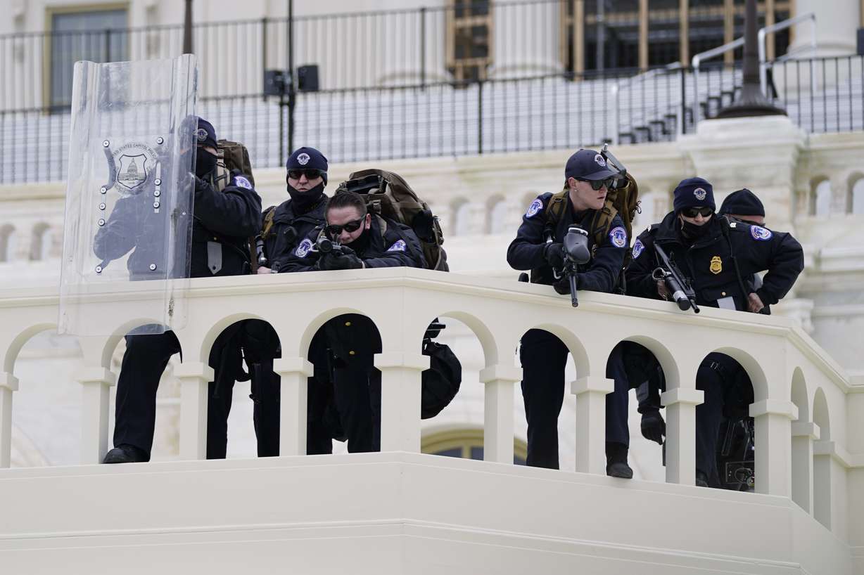FILE - In this Jan. 6, 2021, file photo, police keep a watch on demonstrators who tried to break through a police barrier at the Capitol in Washington. A blistering internal report by the U.S. Capitol Police describes a multitude of missteps that left the force unprepared for the Jan. 6 insurrection — riot shields that shattered upon impact, expired weapons that couldn’t be used, inadequate training and an intelligence division that had few set standards.